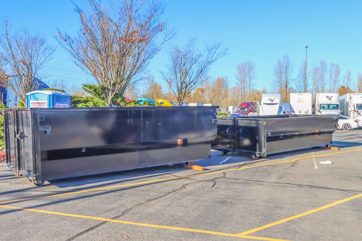 Professional dumpster rental service with roll-off container on residential driveway in Cibolo